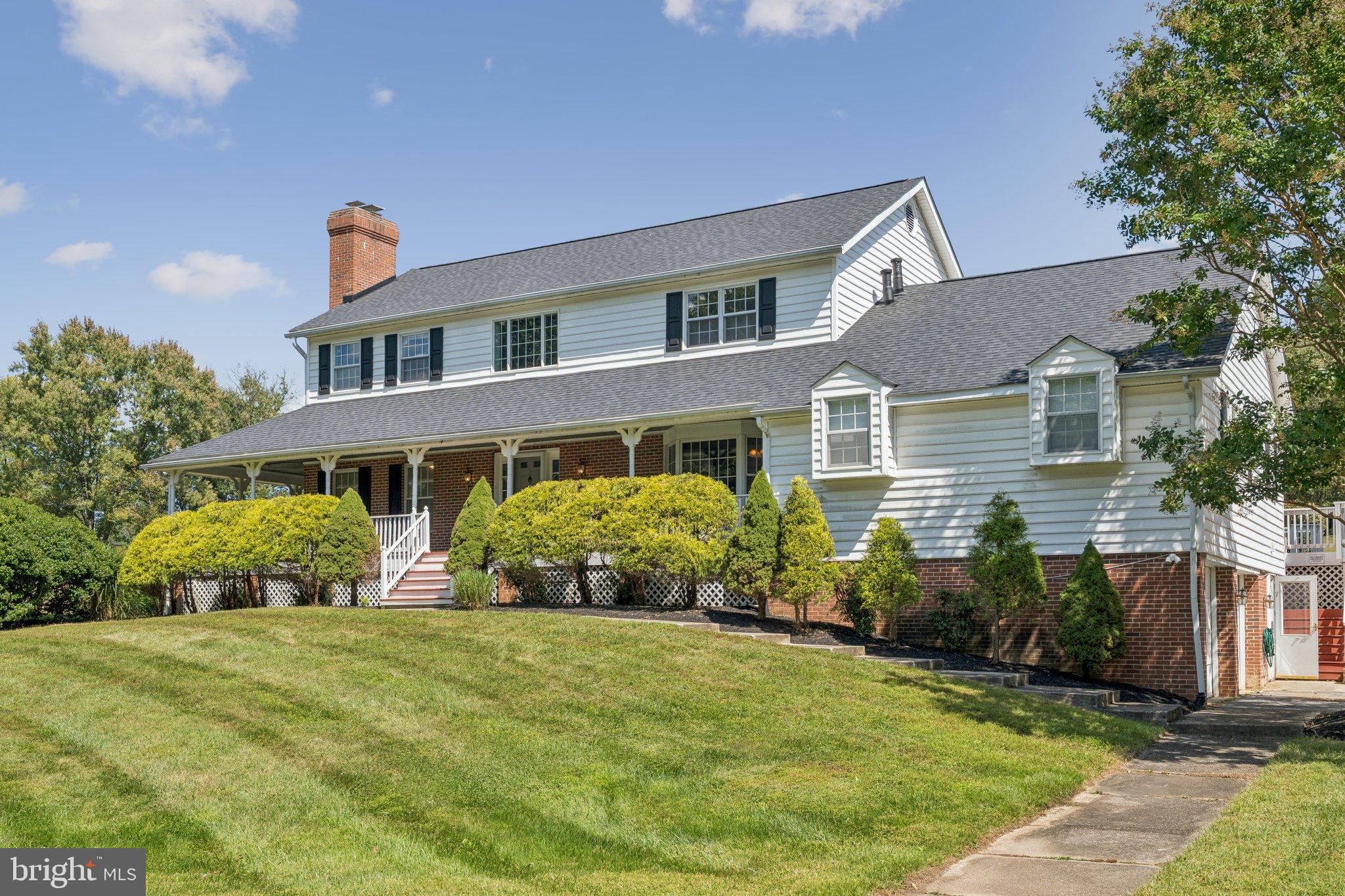 12212 Mt Albert Road Ellicott City, MD 21042 - Photo 4 of 58 a front view of a house with a yard
