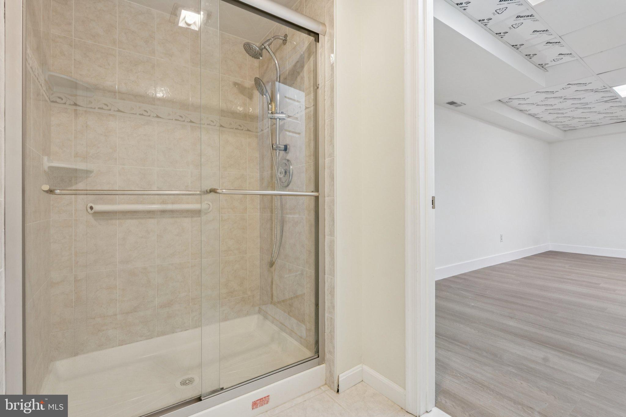 12212 Mt Albert Road Ellicott City, MD 21042 - Photo 44 of 58 a bathroom with a glass shower door