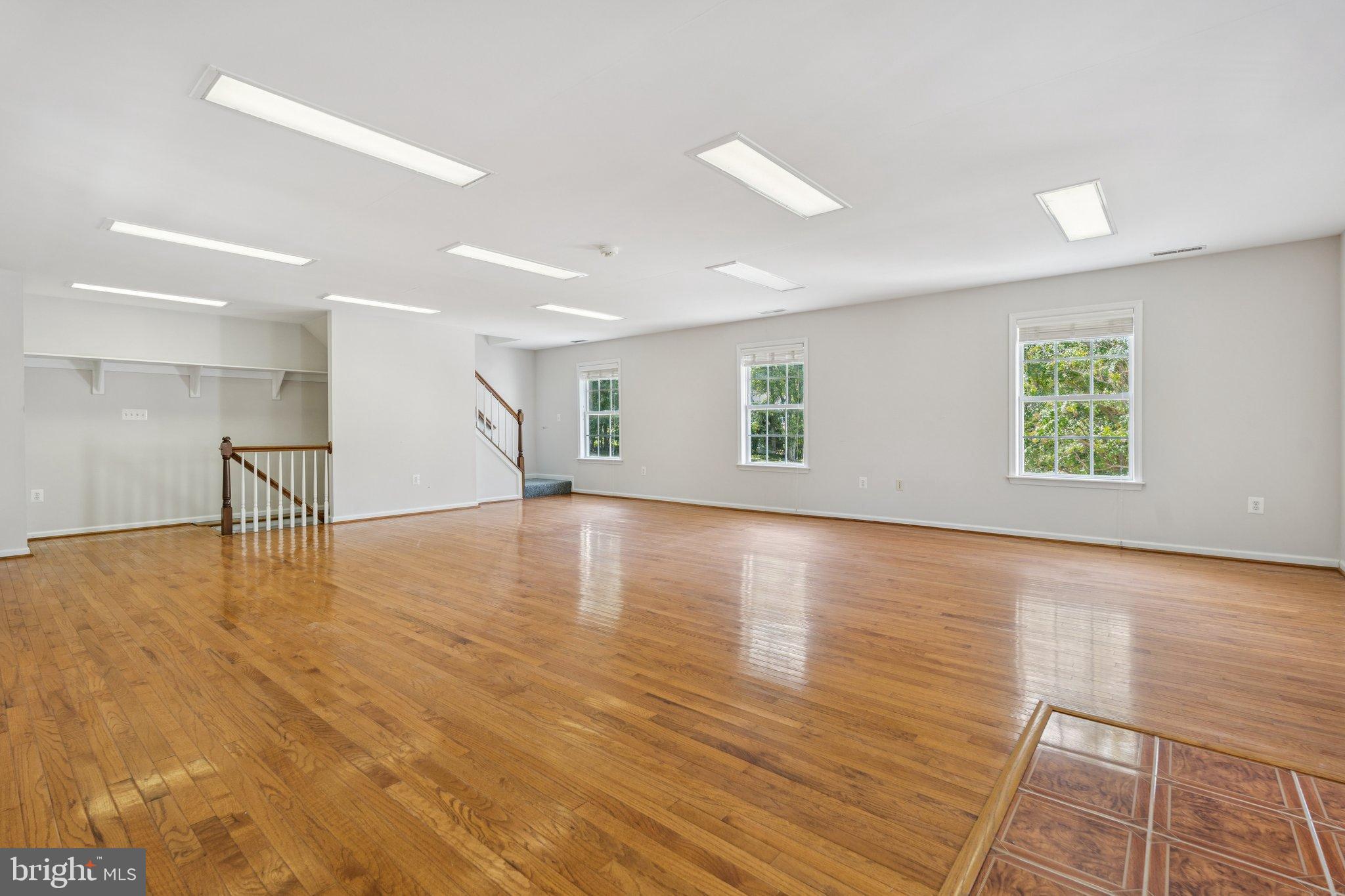 12212 Mt Albert Road Ellicott City, MD 21042 - Photo 48 of 58 a view of an empty room with wooden floor and a window