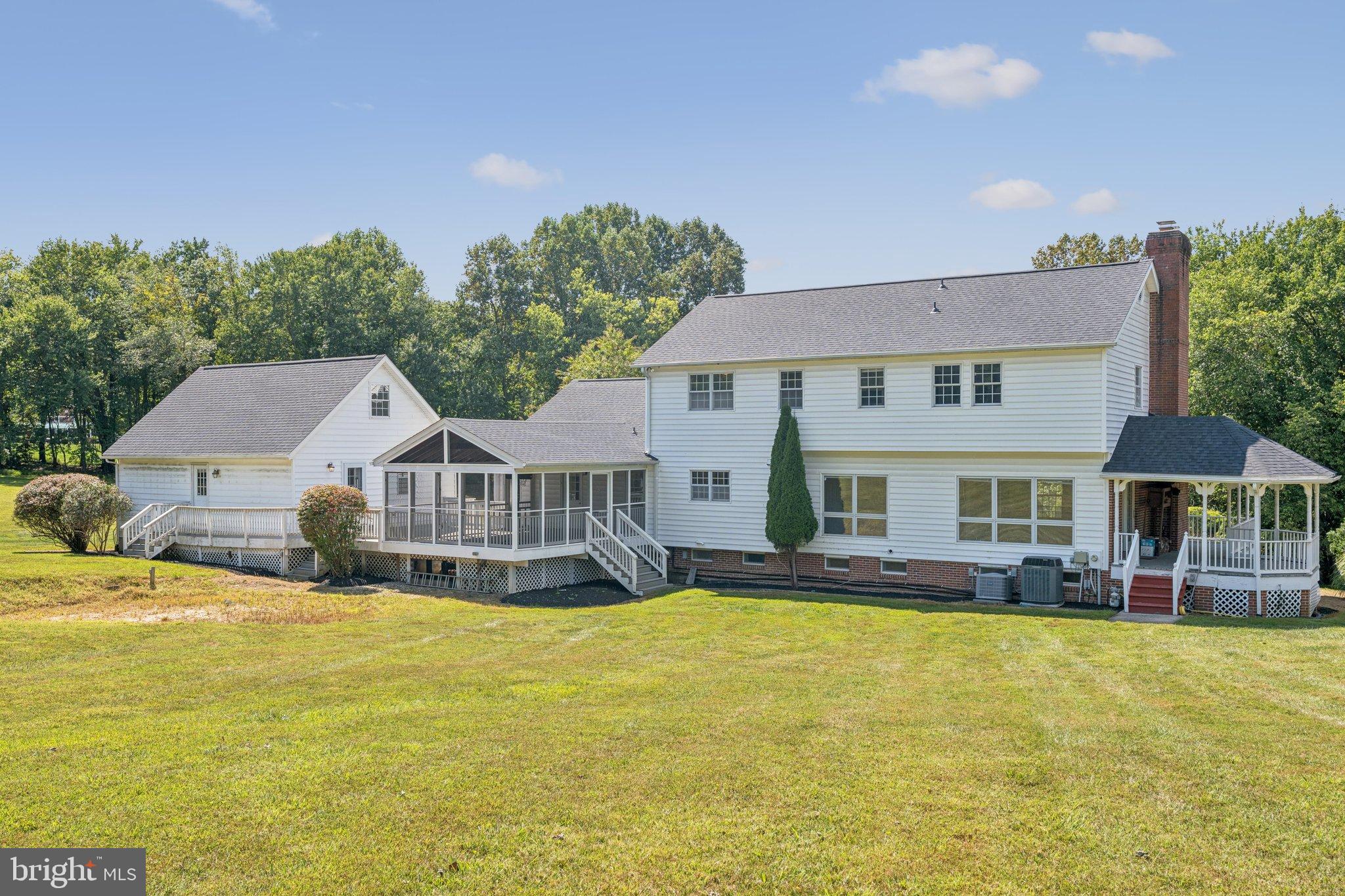 12212 Mt Albert Road Ellicott City, MD 21042 - Photo 51 of 58 a front view of a house with a yard table and chairs