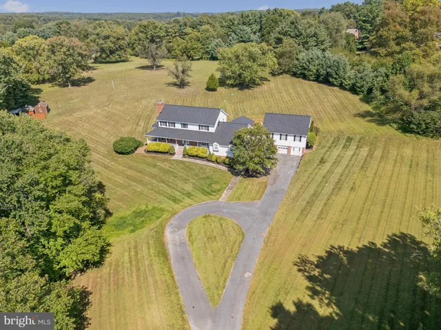 a front view of a house with a yard table and chairs