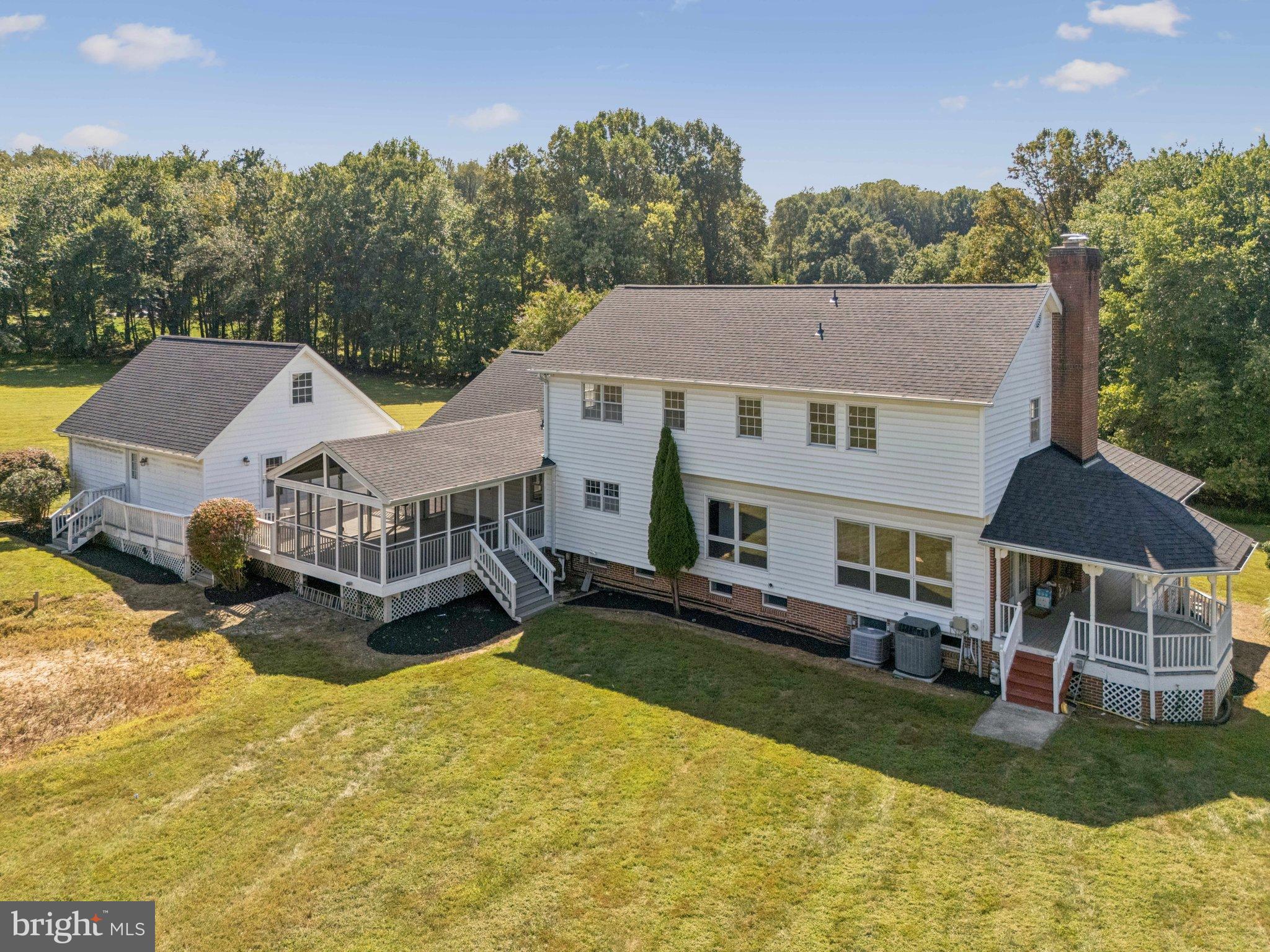 12212 Mt Albert Road Ellicott City, MD 21042 - Photo 7 of 58 a front view of a house with a yard table and chairs