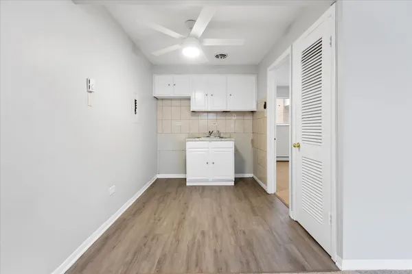 a view of a kitchen with wooden floor and a sink