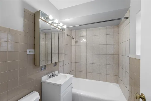 a bathroom with a sink a toilet a shower and a mirror