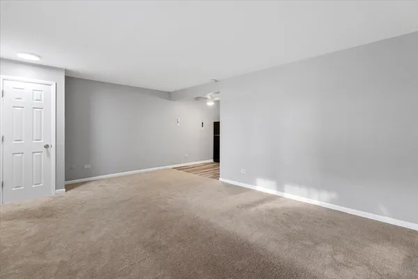 a view of an empty room with a ceiling fan