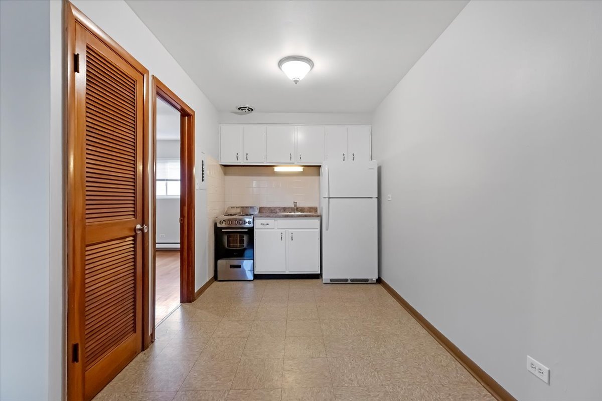 6256 West 64th Place, Unit 104 Chicago, IL 60638 - Photo 10 of 19 a view of a kitchen with a sink and refrigerator