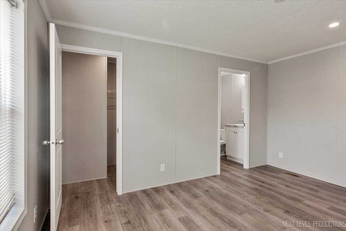 310 Apollo Court Round Lake, IL 60073 - Photo 11 of 38 an empty room with wooden floor and a window