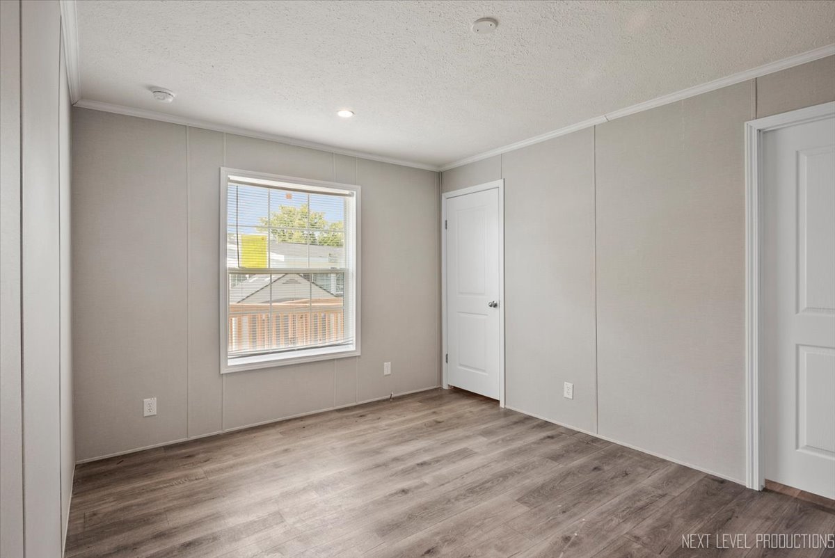 310 Apollo Court Round Lake, IL 60073 - Photo 13 of 38 an empty room with wooden floor and windows
