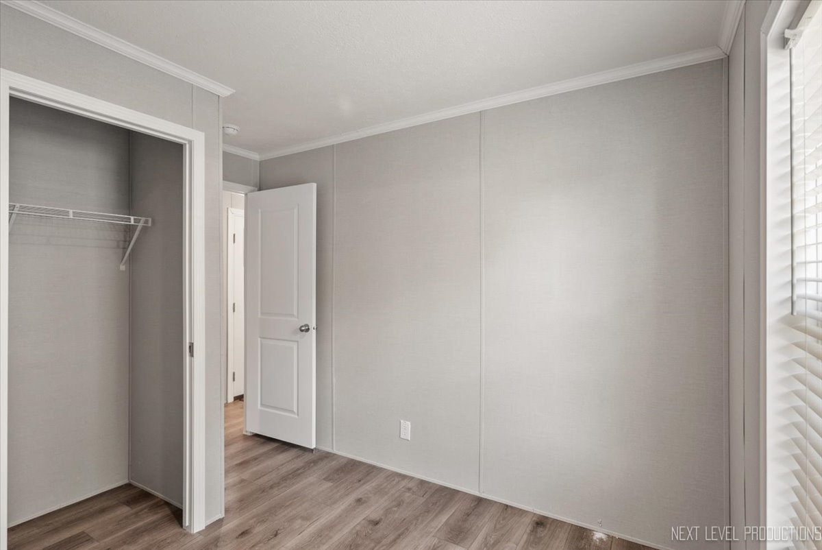 310 Apollo Court Round Lake, IL 60073 - Photo 14 of 38 a view of an empty room with wooden floor and a window