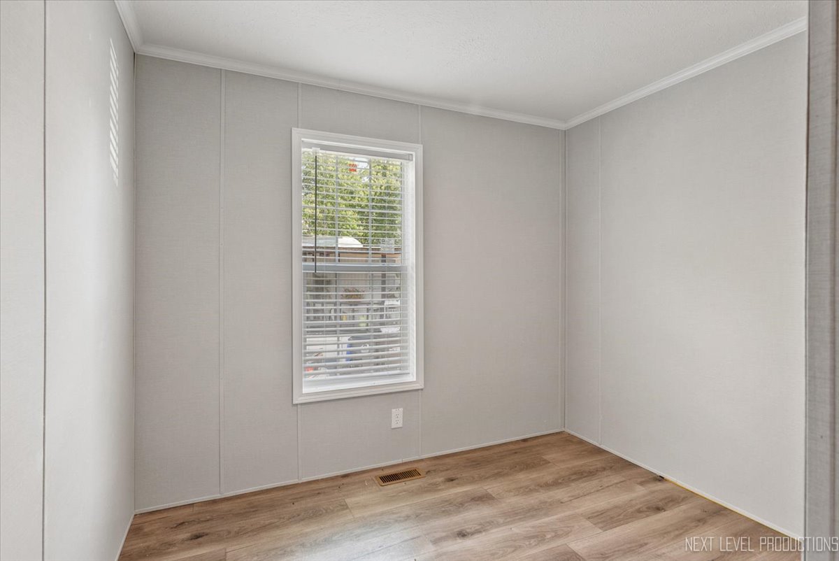 310 Apollo Court Round Lake, IL 60073 - Photo 15 of 38 a view of an empty room with wooden floor and a window