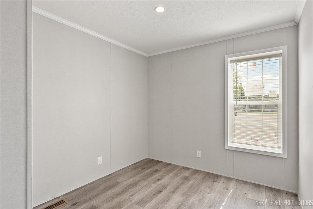 310 Apollo Court Round Lake, IL 60073 - Photo 16 of 38 an empty room with wooden floor and windows
