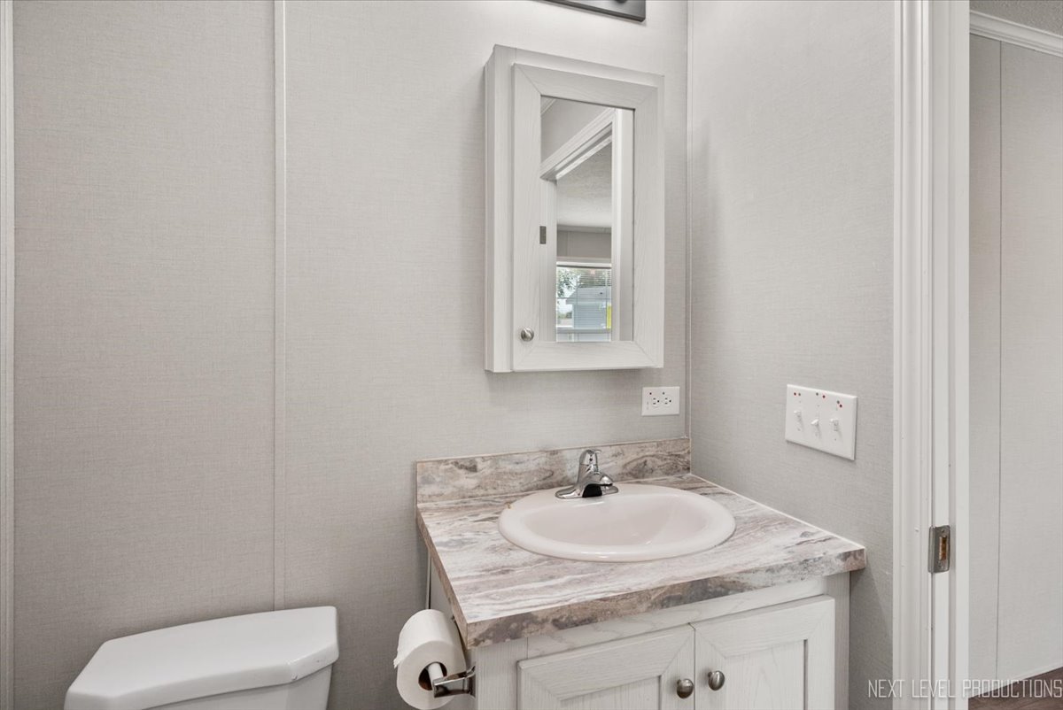 310 Apollo Court Round Lake, IL 60073 - Photo 18 of 38 a bathroom with a sink toilet and mirror