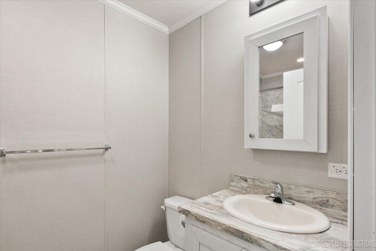 310 Apollo Court Round Lake, IL 60073 - Photo 19 of 38 a bathroom with a sink and a mirror