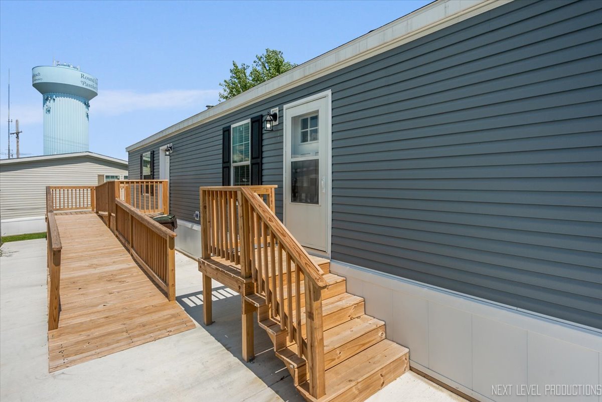 310 Apollo Court Round Lake, IL 60073 - Photo 2 of 38 a view of balcony with wooden floor and fence