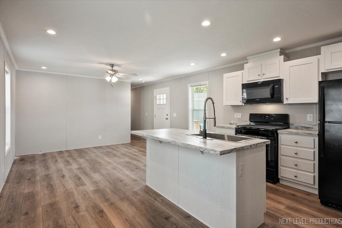 310 Apollo Court Round Lake, IL 60073 - Photo 4 of 38 a kitchen with stainless steel appliances granite countertop a sink stove and microwave