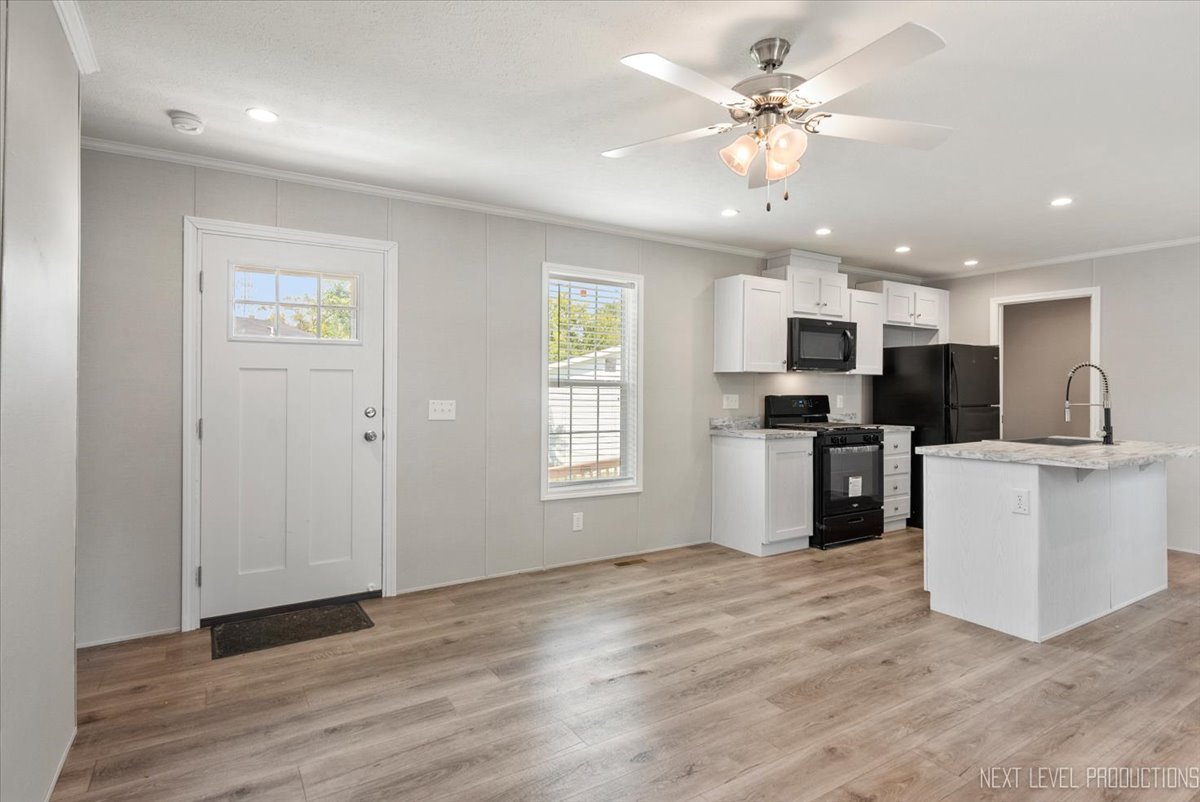 310 Apollo Court Round Lake, IL 60073 - Photo 6 of 38 a view of kitchen with sink microwave refrigerator and cabinets