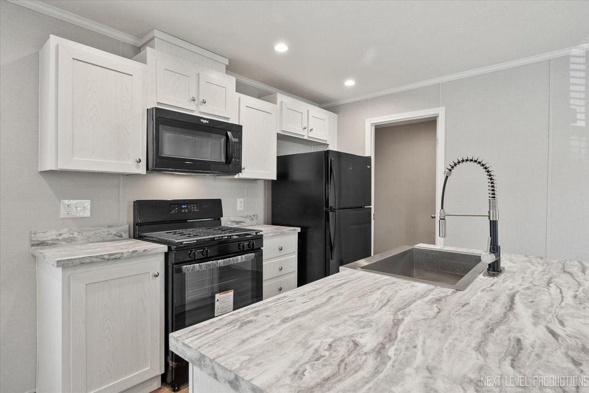 310 Apollo Court Round Lake, IL 60073 - Photo 8 of 38 a kitchen with stainless steel appliances kitchen island a stove a sink and a refrigerator