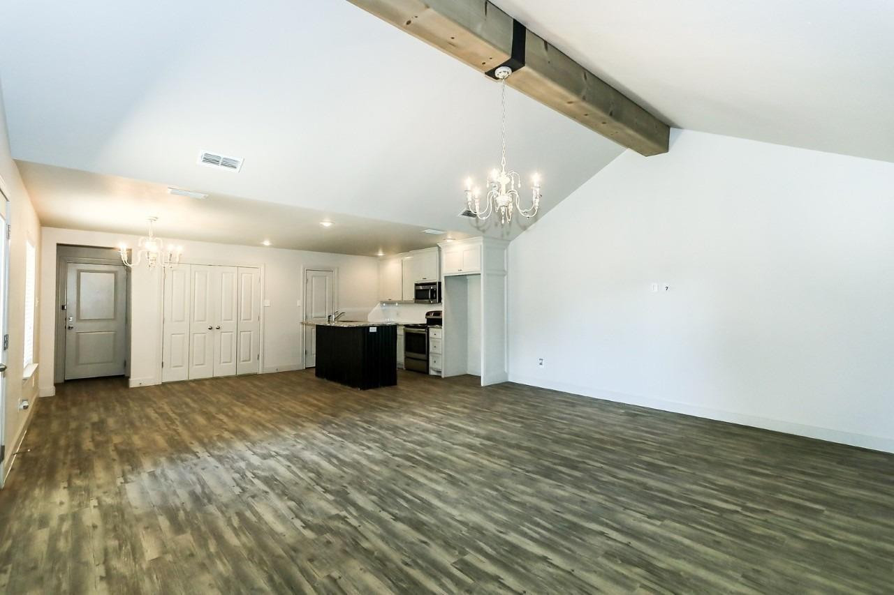 3811 133rd Street Lubbock, TX 79423 - Photo 4 of 12 a view of a kitchen with a sink and a refrigerator