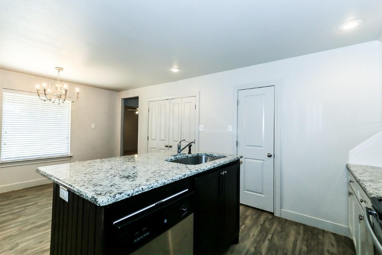 3811 133rd Street Lubbock, TX 79423 - Photo 5 of 12 a bathroom with a granite countertop sink and a mirror