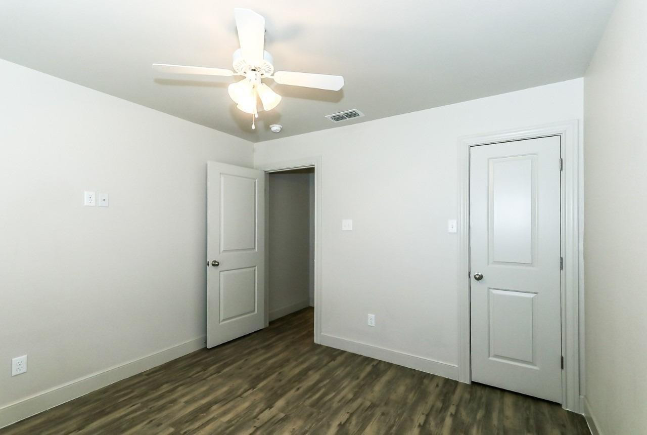 3811 133rd Street Lubbock, TX 79423 - Photo 6 of 12 an empty room with wooden floor and fan
