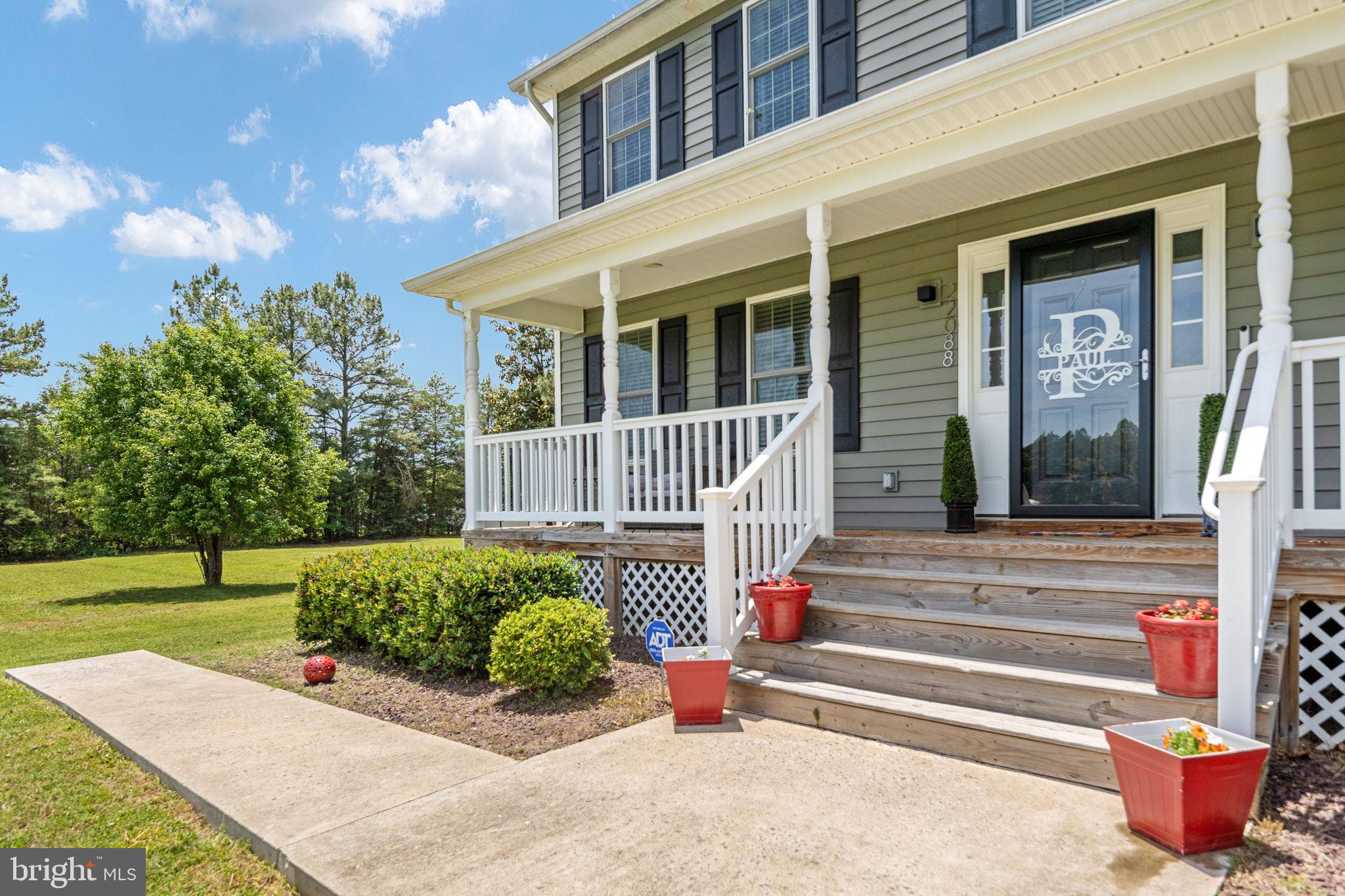 22088 Landora Bridge Road Ruther Glen, VA 22546 - Photo 21 of 122 Charming porch with lush greenery.