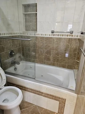 a bathroom with a bathtub and a shower