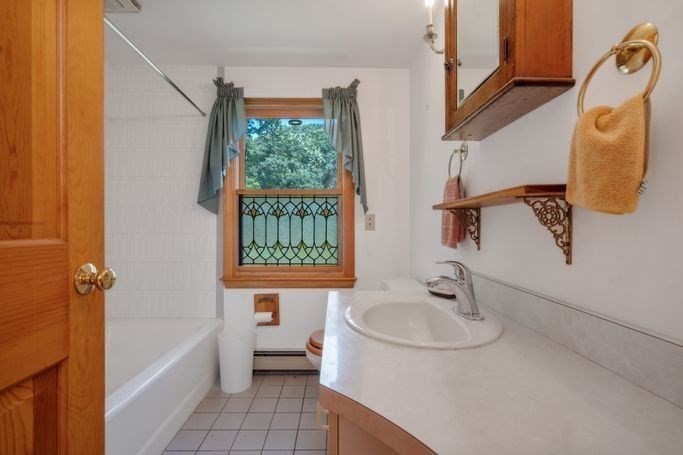 17 Everett Street Sherborn, MA 01770 - Photo 12 of 22 a bathroom with a sink a window and tub