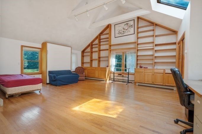 17 Everett Street Sherborn, MA 01770 - Photo 8 of 22 a spacious bedroom with a bed a table and three large mirror with wooden floor