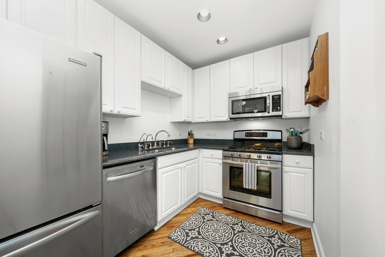 712 West Roscoe Street, Unit 3D Chicago, IL 60657 - Photo 2 of 23 a kitchen with stainless steel appliances granite countertop a stove a sink and a refrigerator