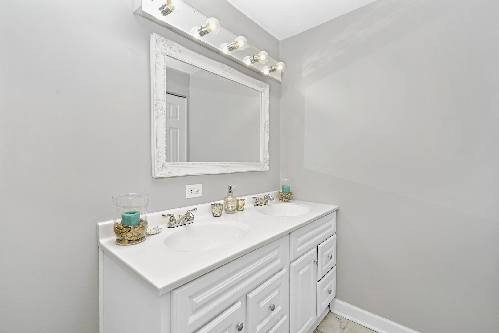 712 West Roscoe Street, Unit 3D Chicago, IL 60657 - Photo 13 of 23 a bathroom with a sink and a mirror