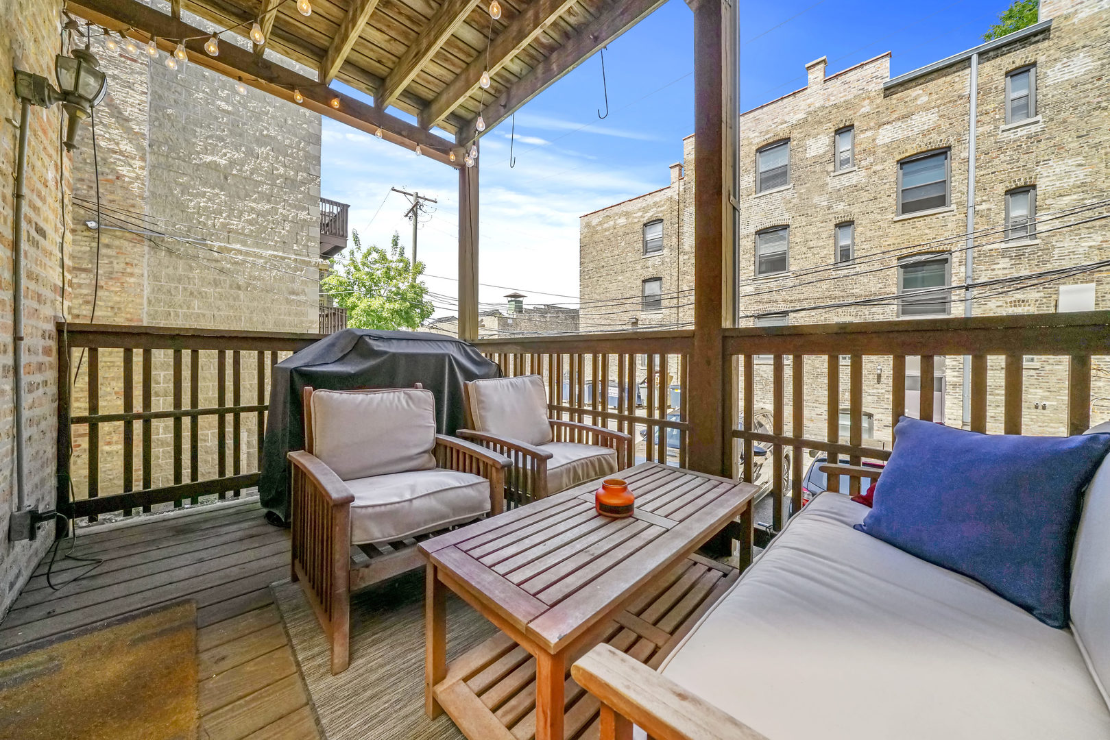 712 West Roscoe Street, Unit 3D Chicago, IL 60657 - Photo 17 of 23 a balcony with wooden benches and furniture