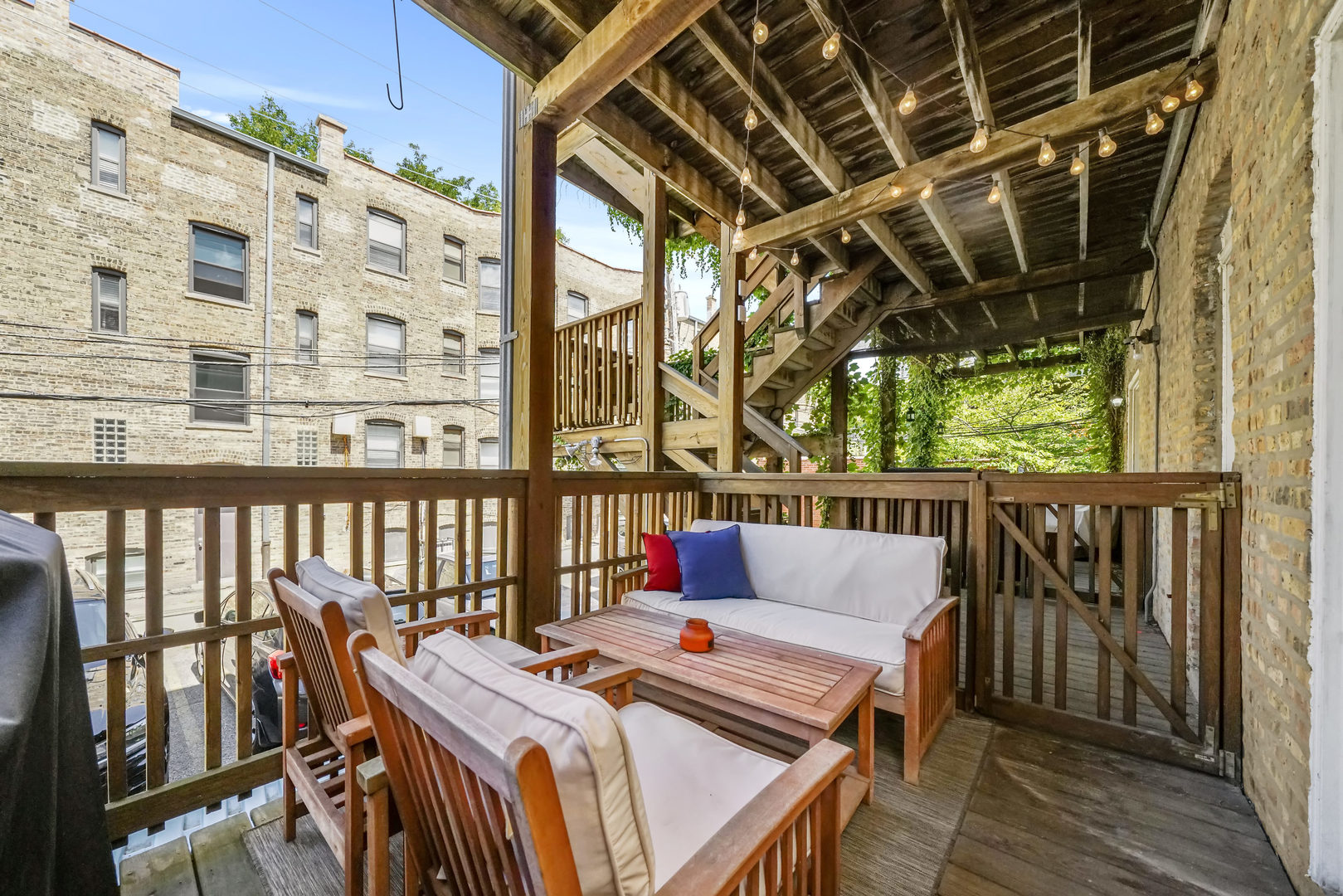 712 West Roscoe Street, Unit 3D Chicago, IL 60657 - Photo 19 of 23 a balcony of a house with wooden floor outdoor seating
