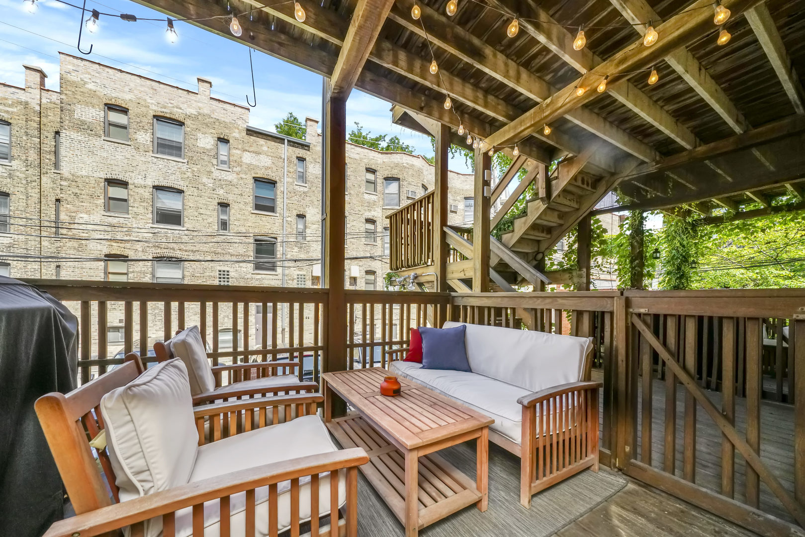 712 West Roscoe Street, Unit 3D Chicago, IL 60657 - Photo 20 of 23 a roof deck with couches and wooden floor