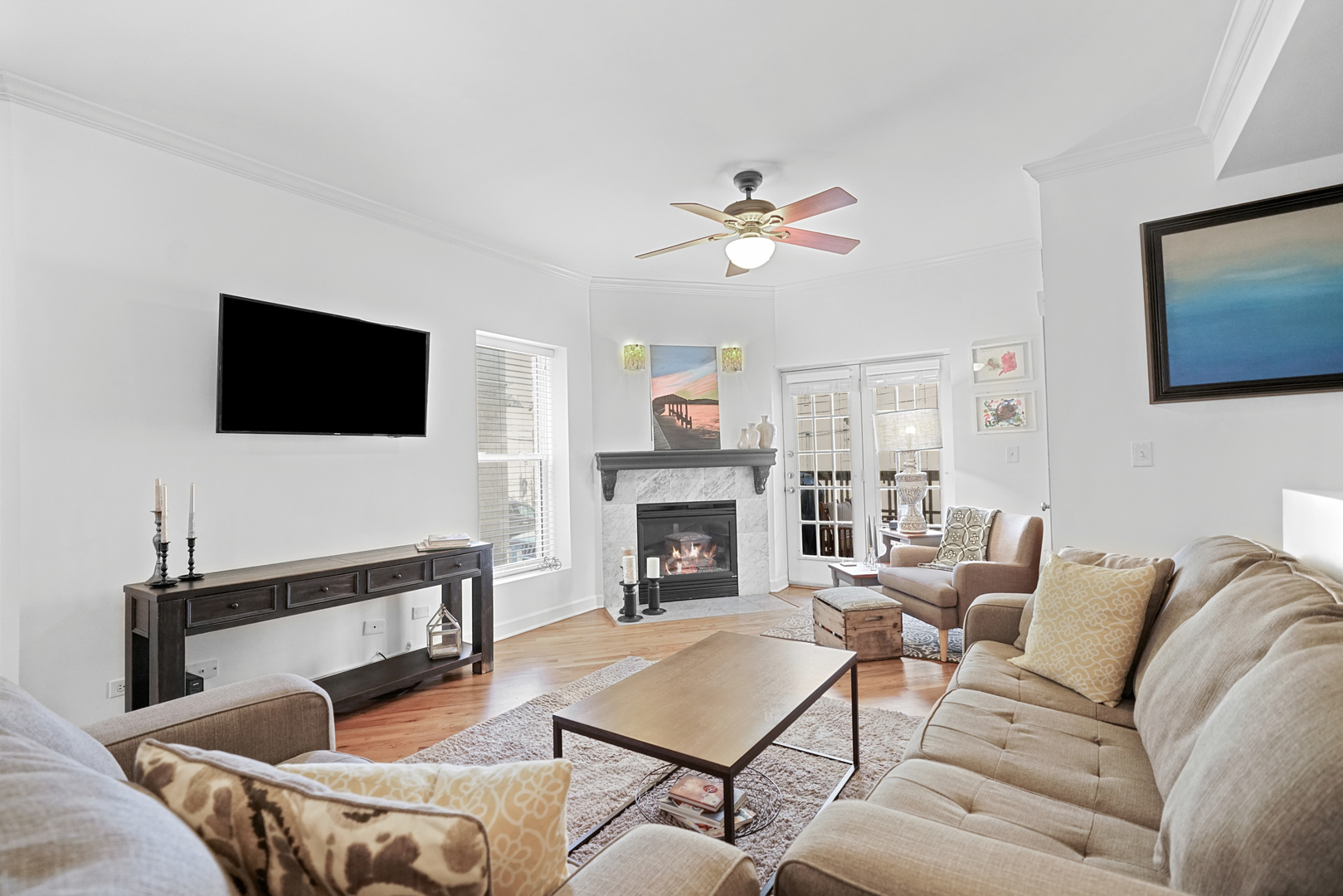 712 West Roscoe Street, Unit 3D Chicago, IL 60657 - Photo 5 of 23 a living room with furniture a fireplace and a flat screen tv
