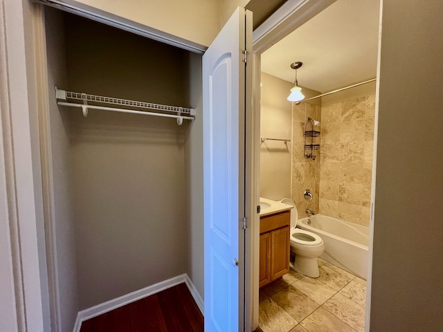 1415 West Lunt Avenue, Unit 304 Chicago, IL 60626 - Photo 11 of 14 a bathroom with a granite countertop sink toilet and shower