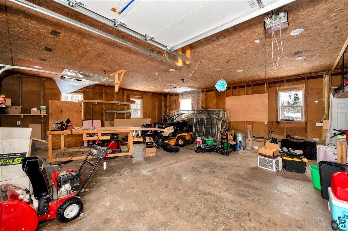 1146 Two Harbors Road Two Harbors, MN 55616 - Photo 26 of 39 Garage featuring wood walls and a garage door opener