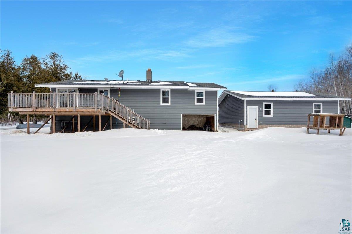 1146 Two Harbors Road Two Harbors, MN 55616 - Photo 29 of 39 Snow covered back of property featuring a deck and a chimney