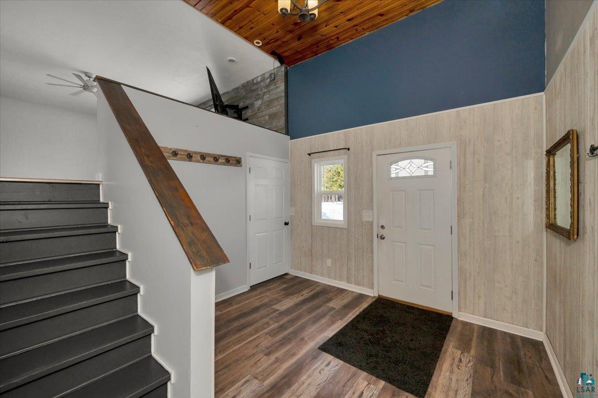 1146 Two Harbors Road Two Harbors, MN 55616 - Photo 3 of 39 Foyer entrance with dark wood finished floors, wooden ceiling, wood walls, and a ceiling fan