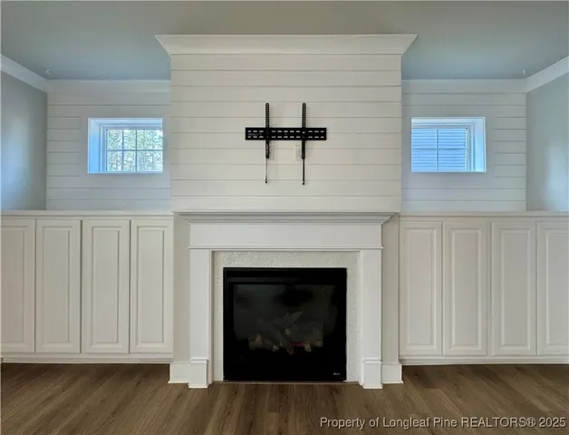 a large kitchen with stainless steel appliances kitchen island granite countertop a refrigerator a stove a sink dishwasher and a dining table with wooden floor