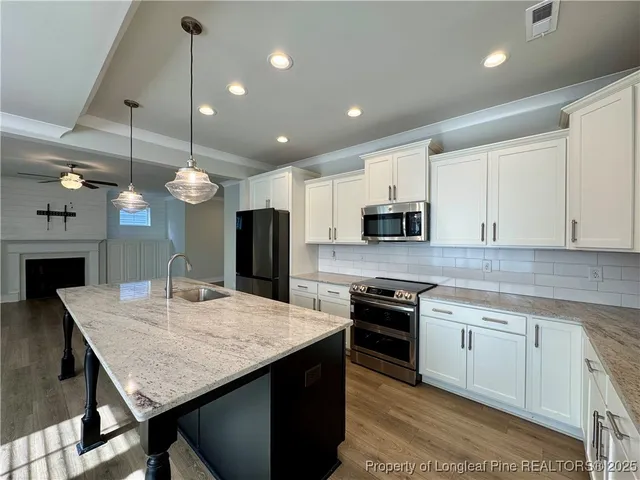 a kitchen with stainless steel appliances a refrigerator sink and microwave