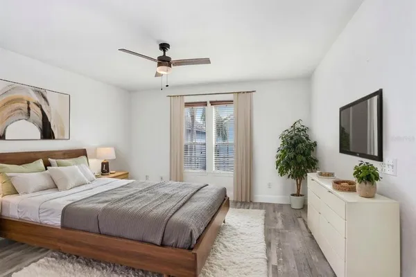 a bedroom with a large bed and a flat screen tv