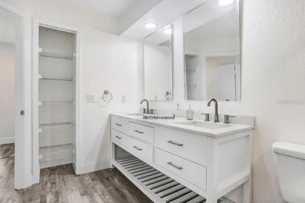 a bathroom with a double vanity sink and mirror