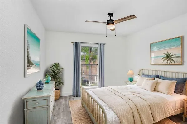 a bedroom with a bed and a potted plant