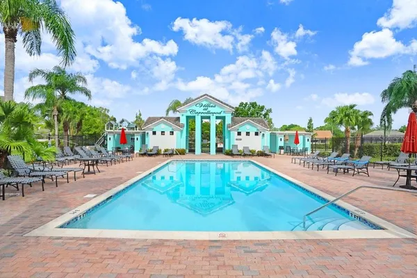 a swimming pool with outdoor seating and yard