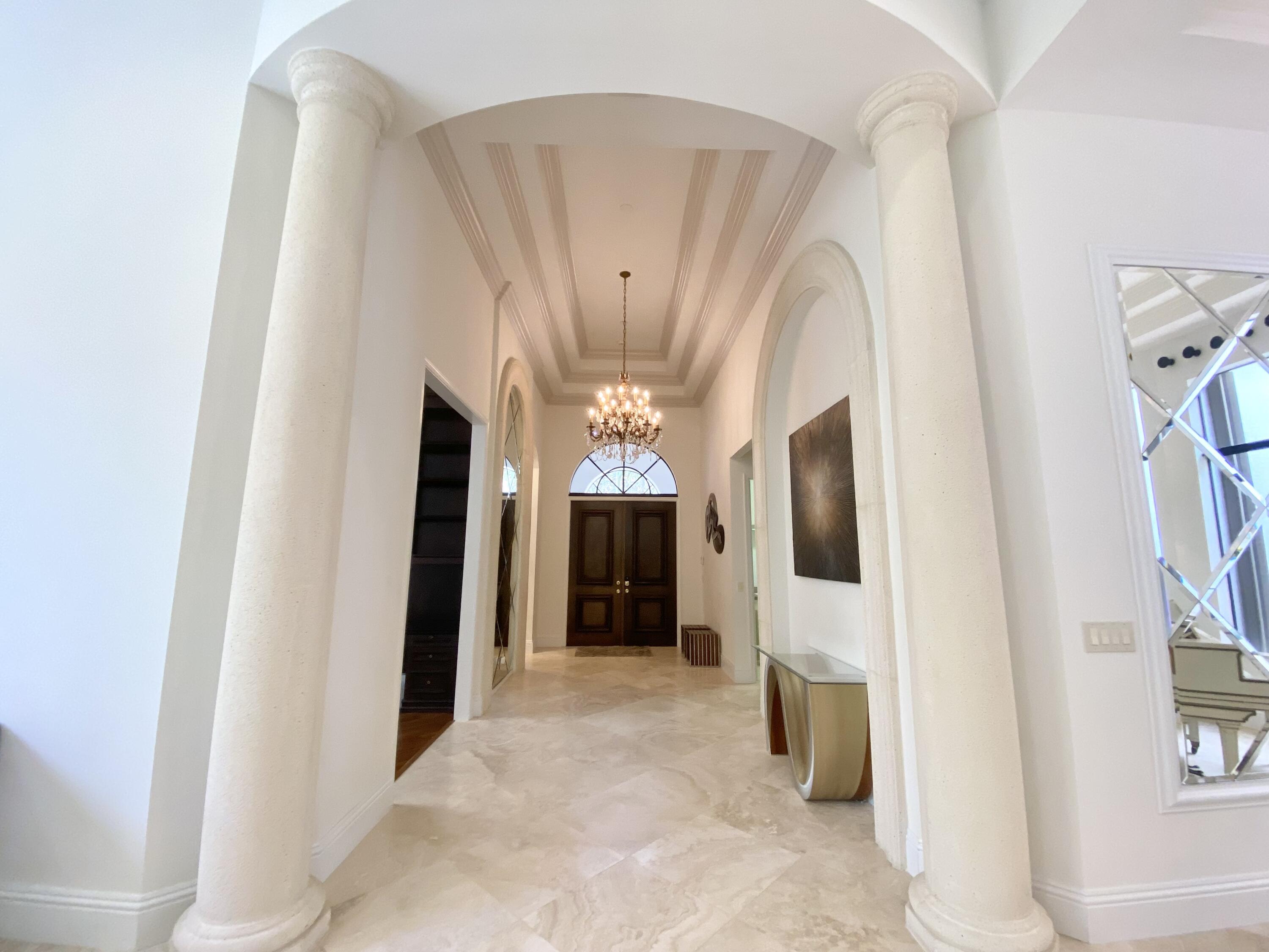 17754 Lake Azure Way Boca Raton, FL 33496 - Photo 2 of 30 a view of a hallway with windows and chandelier