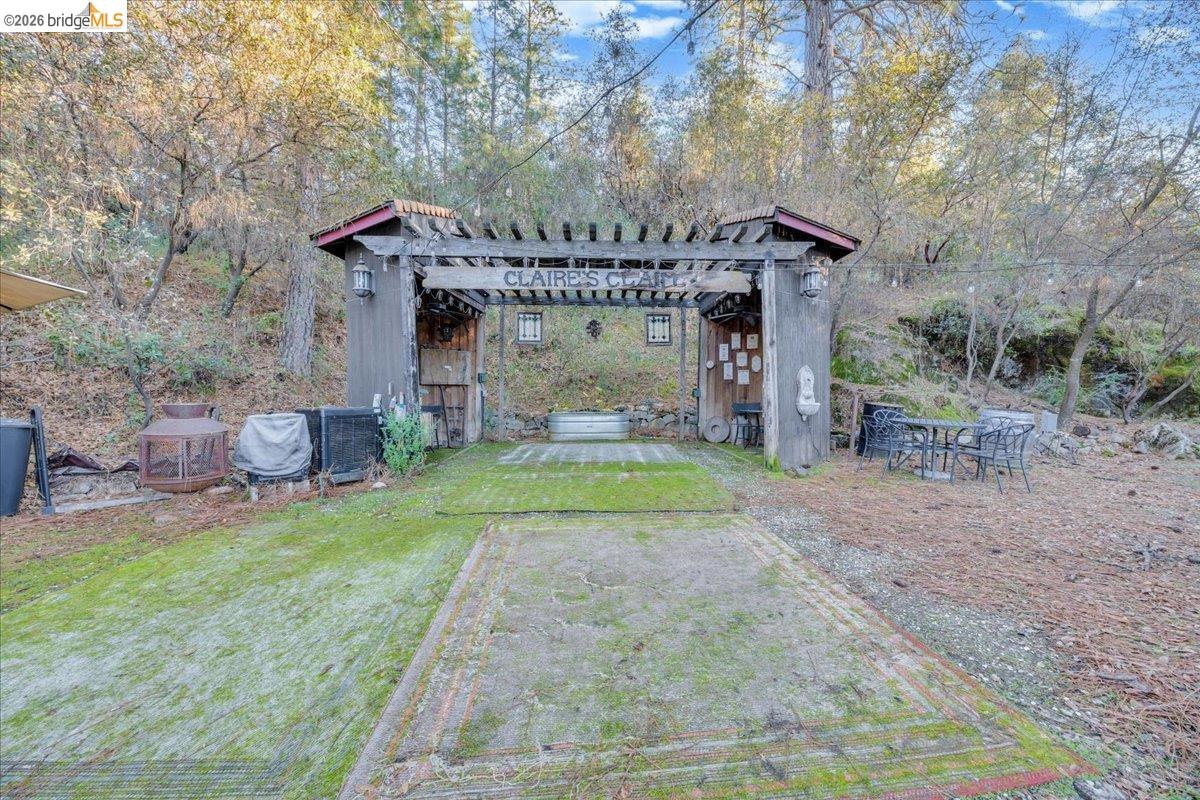 22389 Parrotts Ferry Road Columbia, CA 95310 - Photo 23 of 60 View of grassy yard with a pergola and a patio area