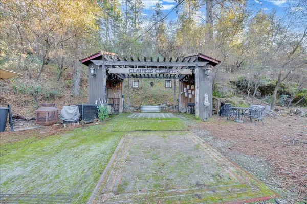 a stone house with trees in front of it