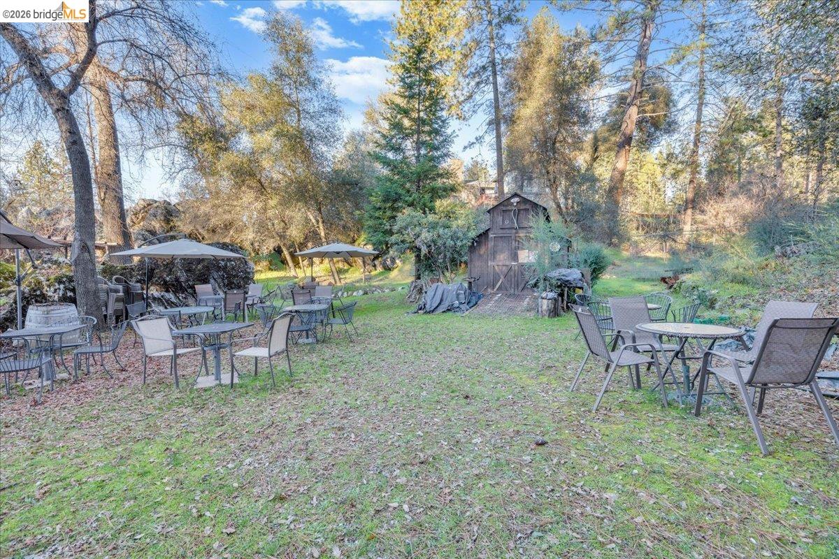 22389 Parrotts Ferry Road Columbia, CA 95310 - Photo 24 of 60 a view of a fire pit in a backyard