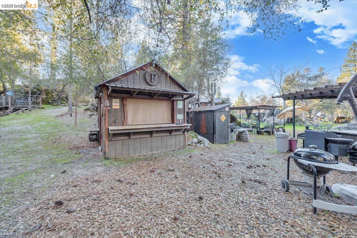 22389 Parrotts Ferry Road Columbia, CA 95310 - Photo 25 of 60 a view of a house with a yard