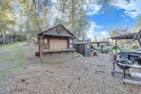 a backyard of a house with table and chairs